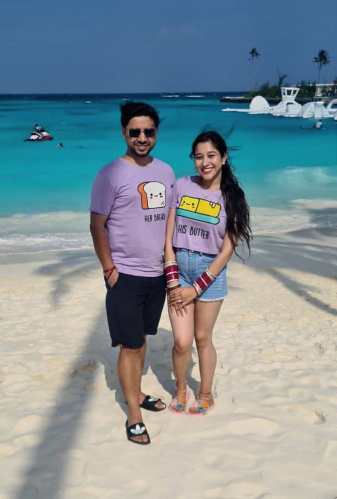 Real-life couple wearing Matchy couple tees on their honeymoon posing on beach side