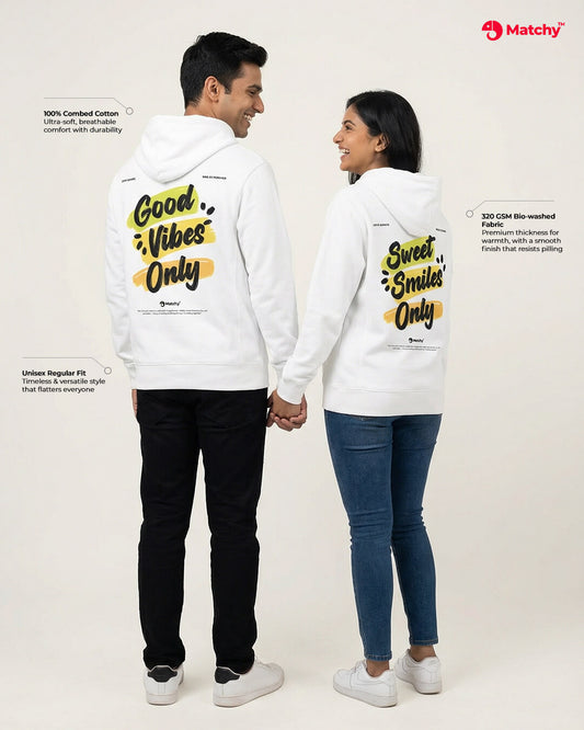 couple hoodies with prints 'Good vibes only' & 'Sweet smiles only' worn by a couple in white color, back view.