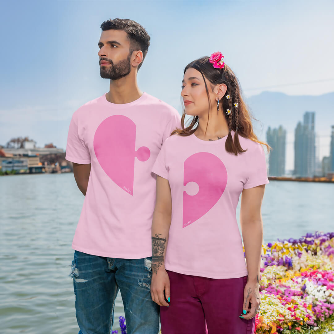 Couple standing on boat wearing pink Matchy couple tshirts with half puzzle heart on male tee & half puzzle heart on female tee